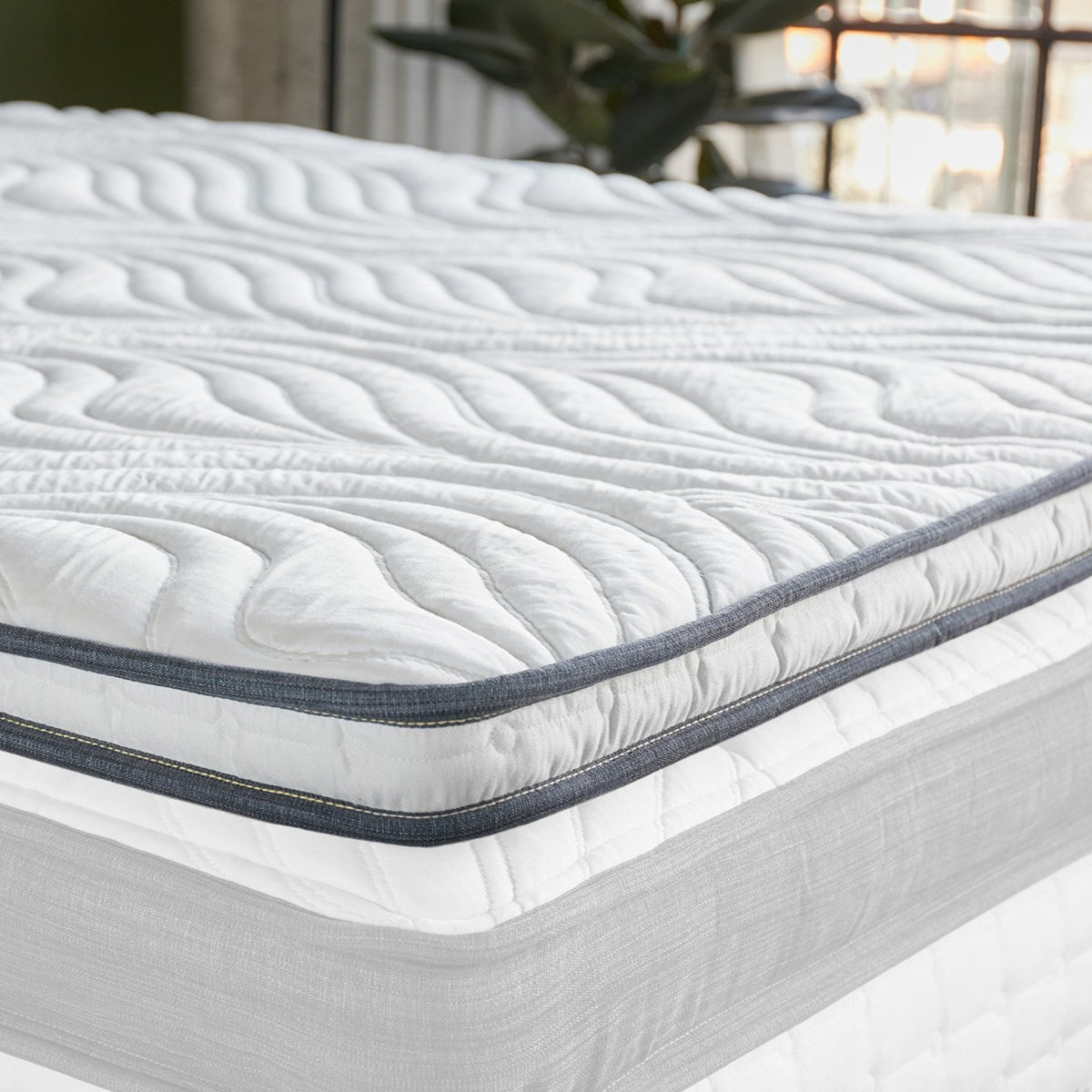 Memory foam mattress topper on a clean white mattress