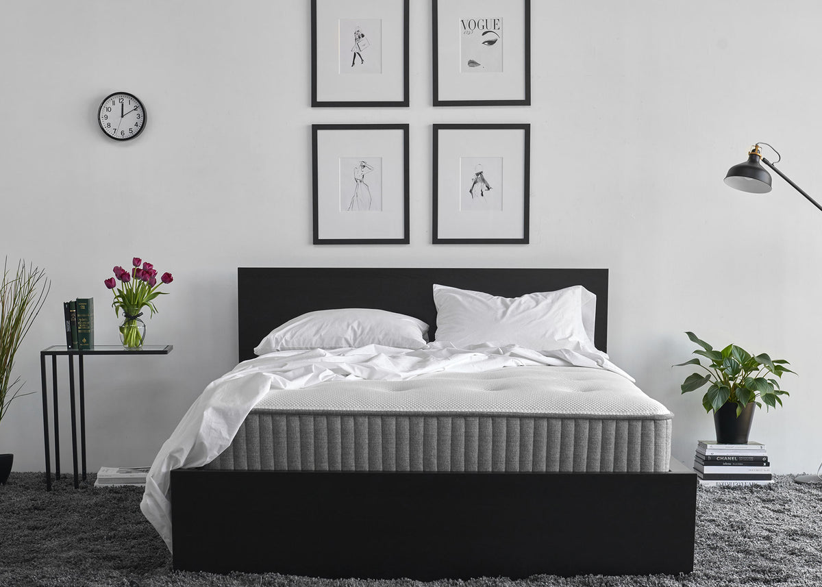 Charcoal-infused memory foam mattress against a white wall in a decorated bedroom